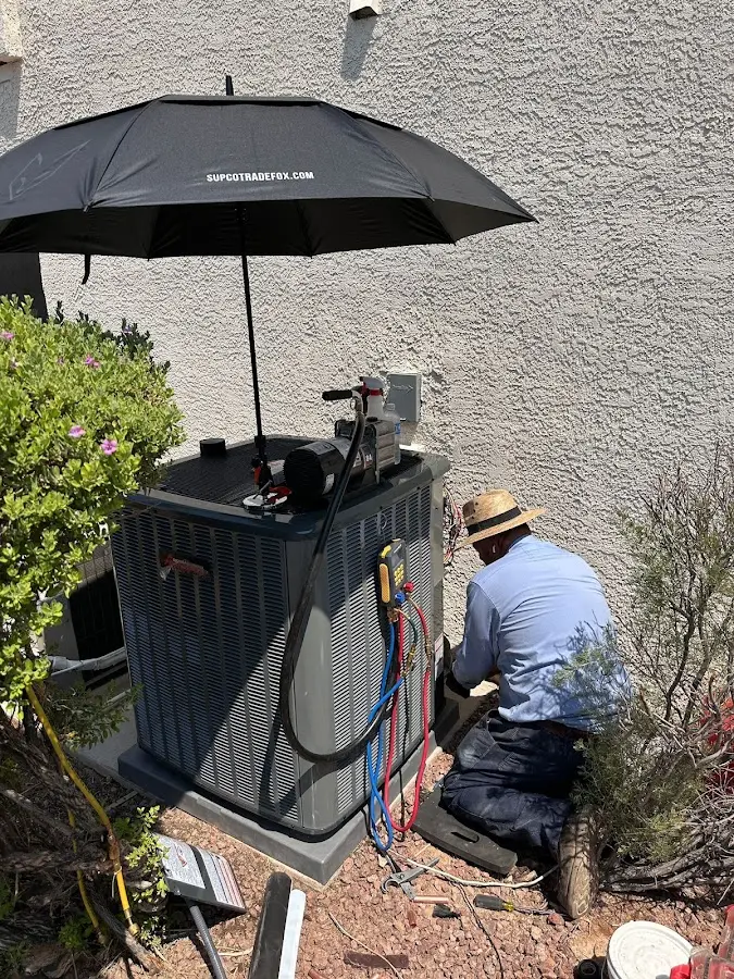 HVAC technician performing outdoor AC maintenance in Corona de Tucson